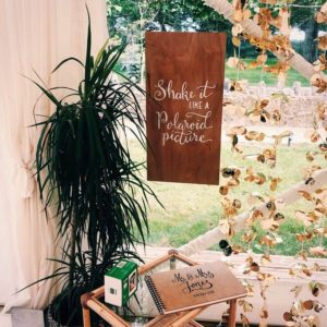 Custom calligraphy photobooth signage and bespoke wedding album with couples names and date