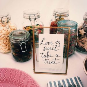 Love is sweet take a treat calligraphy sign in a frame